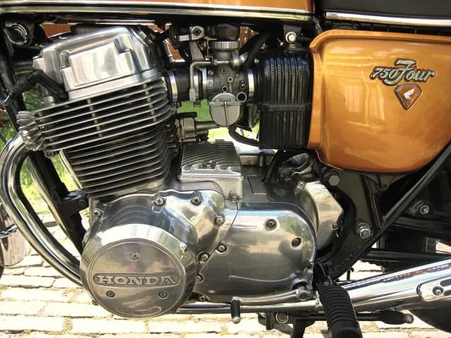 Close-up of a 1973 Honda CB750 four-cylinder engine and gold fuel tank