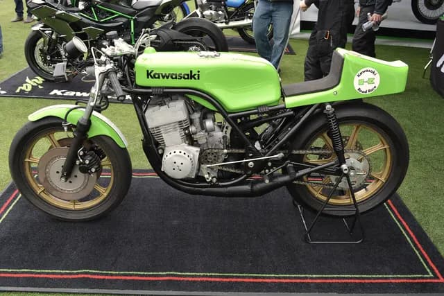 A green 1970s Kawasaki race bike on display